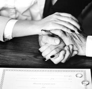 Person Holding Their Hands On Brown Wooden Table photo