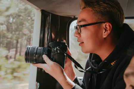 Photo Of Man Holding Nikon Dslr Camera photo