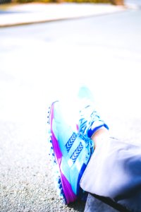 Person Wearing Pair Of Blue-and-pink Running Shoes photo