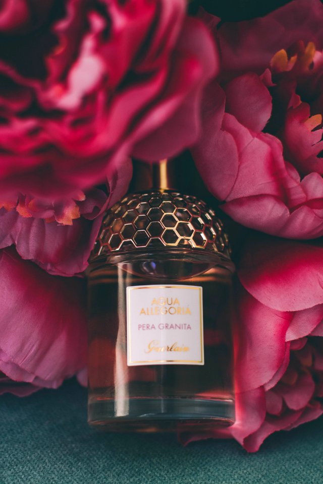 Perfume Bottle Surrounded By Flowers