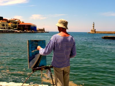 Man In White And Blue Striped Long-sleeved Shirt Painting Near Seashore photo
