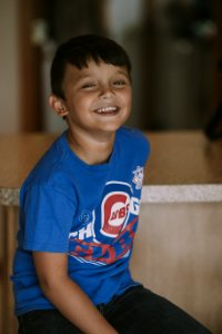 Person Taking Photo Of Boy In Blue Chicago Cubs Crew-neck T-shirt In Tilt Shift Photography