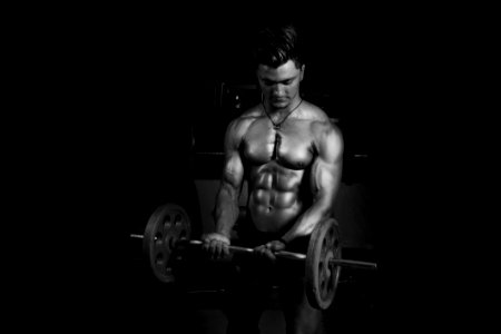 Grayscale Photography Of Man Carrying Barbell photo