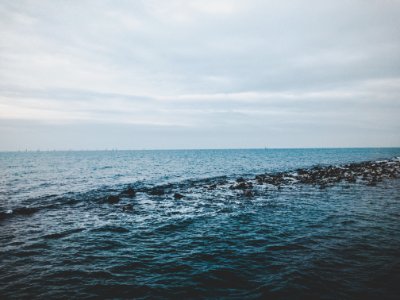 Photography Of Ocean Under Cloudy Sky photo
