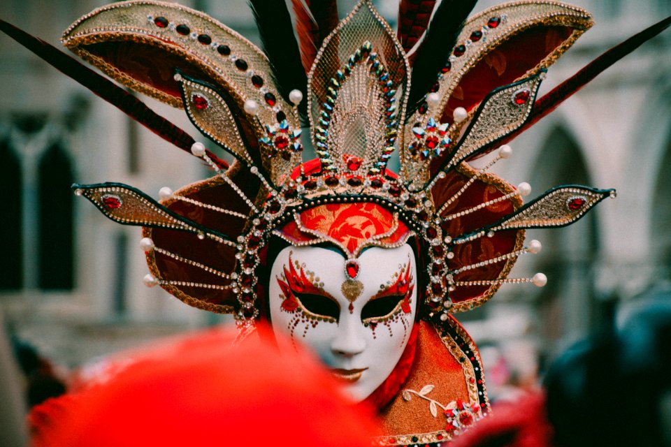 Person Wearing White And Orange Volto Mask
