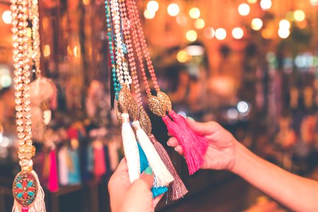 Person Holding Assorted-colored Tassel Necklace Lot