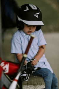 Boy Wearing Black And White Baseball Helmet And Gloves