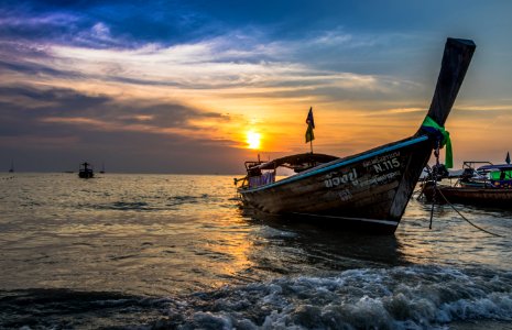 Photo Of Brown Boat At Sea During Golden Hour photo