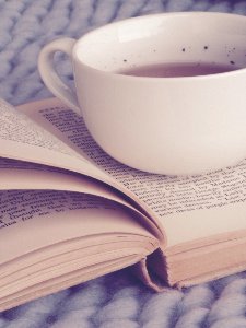White Ceramic Cup On Top Of Book photo