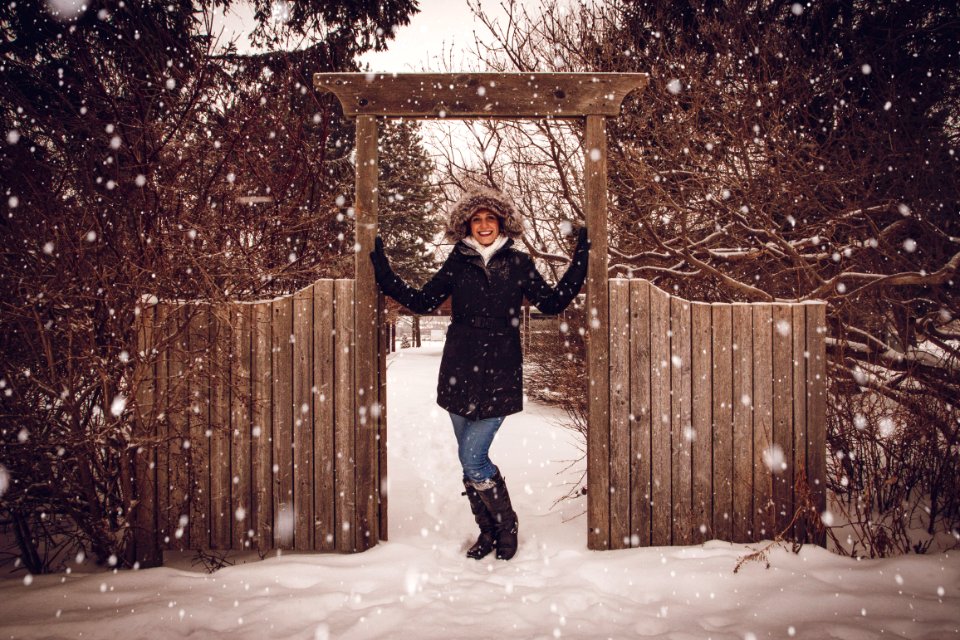 Woman In Black Coat Beside Fence During Snow