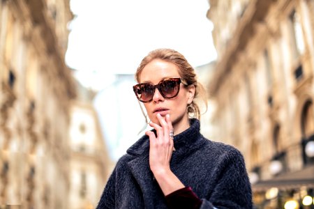Woman Wearing Black Coat And Brown Framed Sunglasses