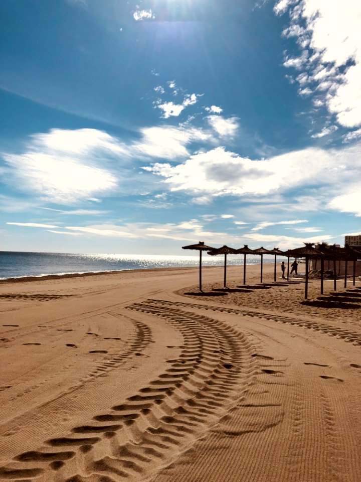 Brown Sand Near Seashore Under Cloudy Sky