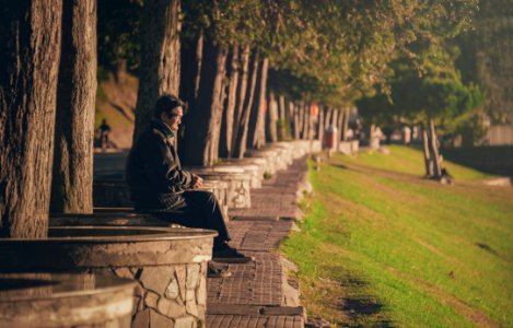 Man Seating On Concrete Base photo