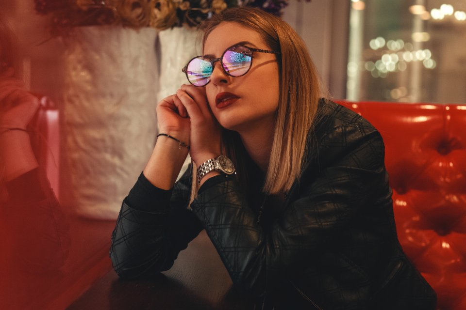 Woman Wearing Eyeglasses Sitting Down