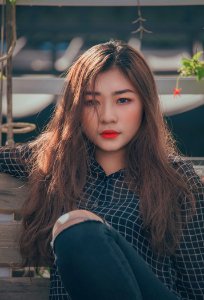 Woman In Black And White Gingham Button-up Shirt And Distress Black Denim Jeans