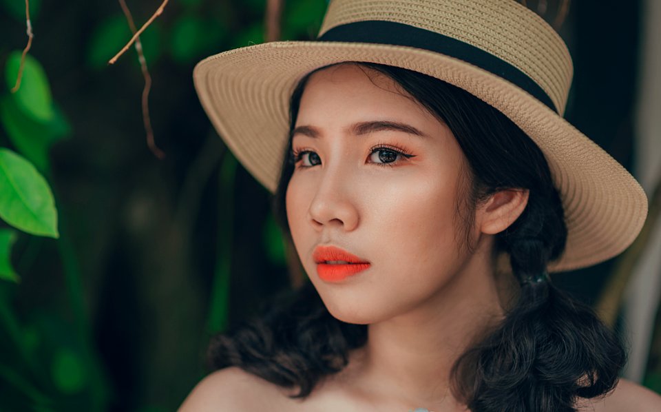 Woman With Pony-tailed Hair Wearing Brown And Blue Straw Hat