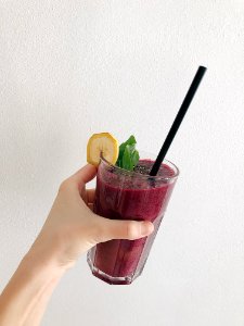 Persons Holding Fruit Drink photo