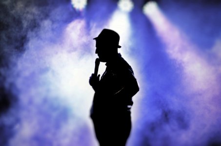 Man Holding Microphone Silhouette photo