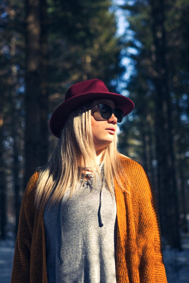 Woman In Brown Cardigan And Gray Top Near Green Leaf Trees At Daytime photo