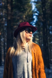 Woman In Brown Cardigan And Gray Top Near Green Leaf Trees At Daytime photo