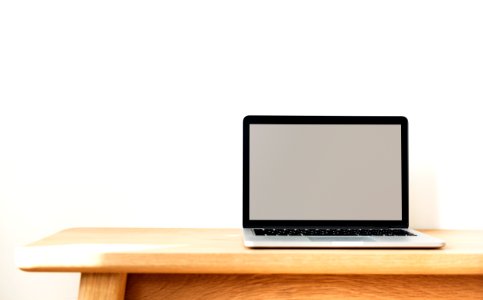 Macbook Pro On Brown Wooden Table