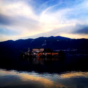 Buildings Near Body Of Water And Mountain photo