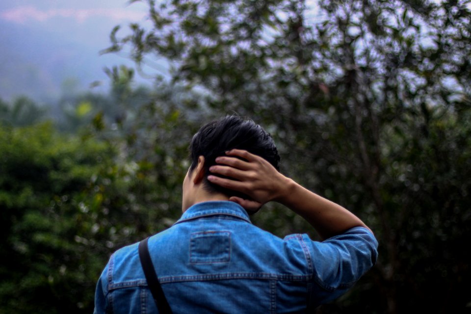 Person In Blue Denim Jacket