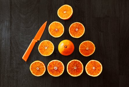 Sliced Orange Fruit With Knife photo