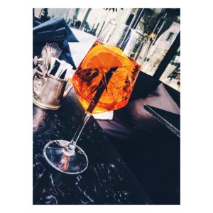 Clear Long-stemmed Glass With Orange Liquid photo