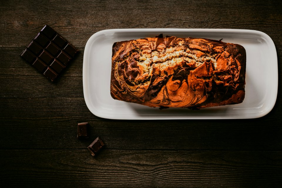Chocolate Cake In White Plate Beside Chocolate Bars