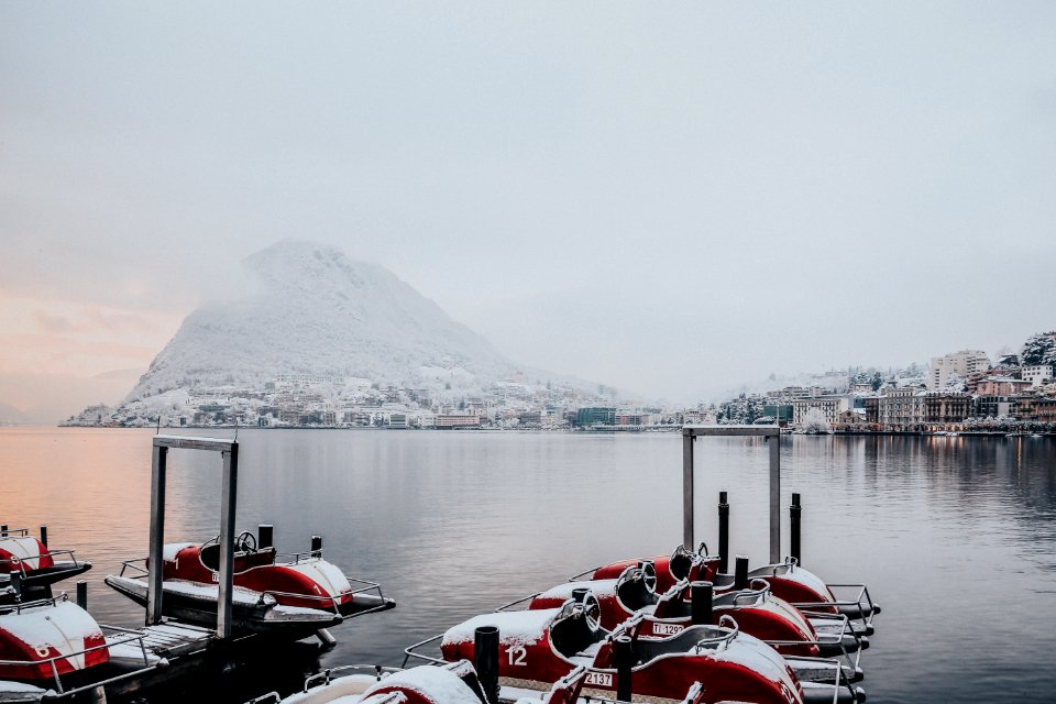 White And Red Boats On Dock Near White Snowy Mountain