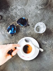 Person Holding White Ceramic Cup Filled With Coffee photo