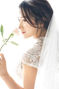 Woman Wearing White Lace Encrusted Wedding Gown And Veil photo