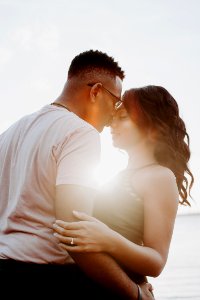 Man Wearing White Shirt Kissing Woman In Her Nose photo