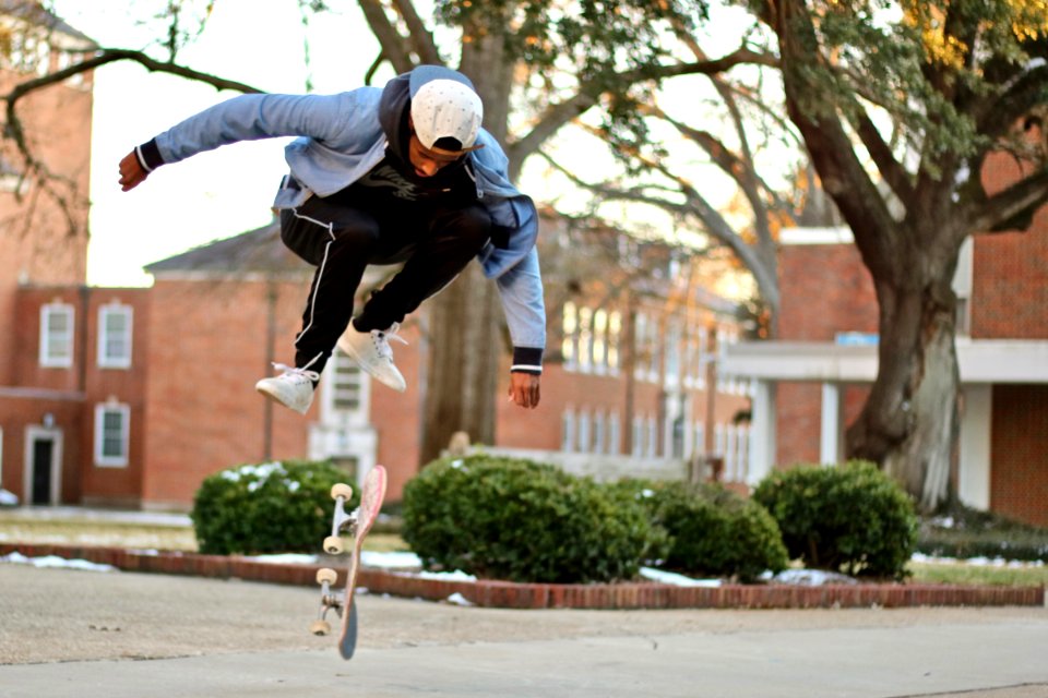 Man Jumps Over Skateboard