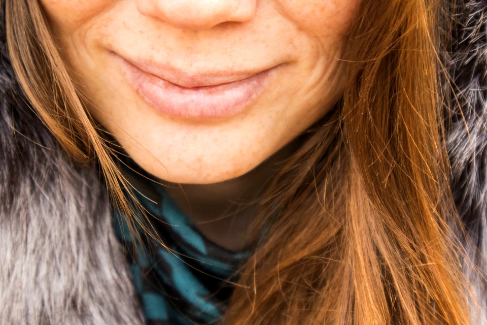 Smiling Woman Wearing Gray Fur Top
