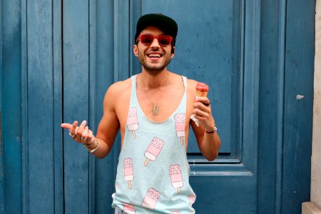 Person In Teal Ice Cream Print Tank Top Holds Ice Cream photo