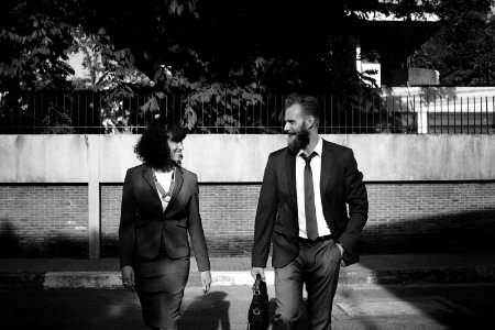 Grayscale Photo Of Man And Woman In Formal Suits photo