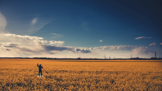 Man On Field Under Blue Cloudy Sky photo