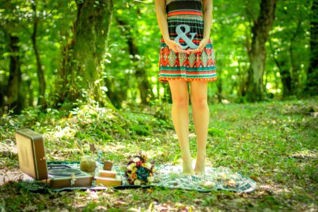 Woman Standing On Picnic Mat Holding Ampersand Lettering