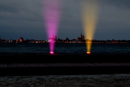 Two Purple And Orange Lights On Top Of Brown Surface photo