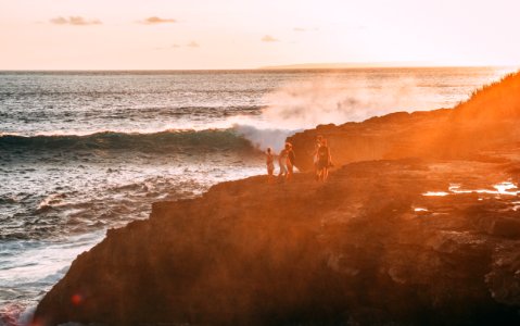 People Standing On Cliff Near Body Of Water Golden Hour Photography photo