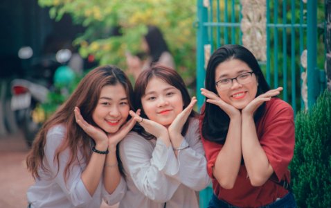 Three Girls Wearing White And Red Dress Shirts photo