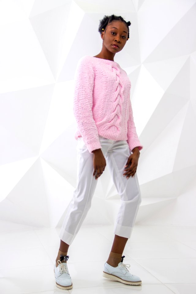 Woman In Sweater And Pants Taking Selfie With White Background