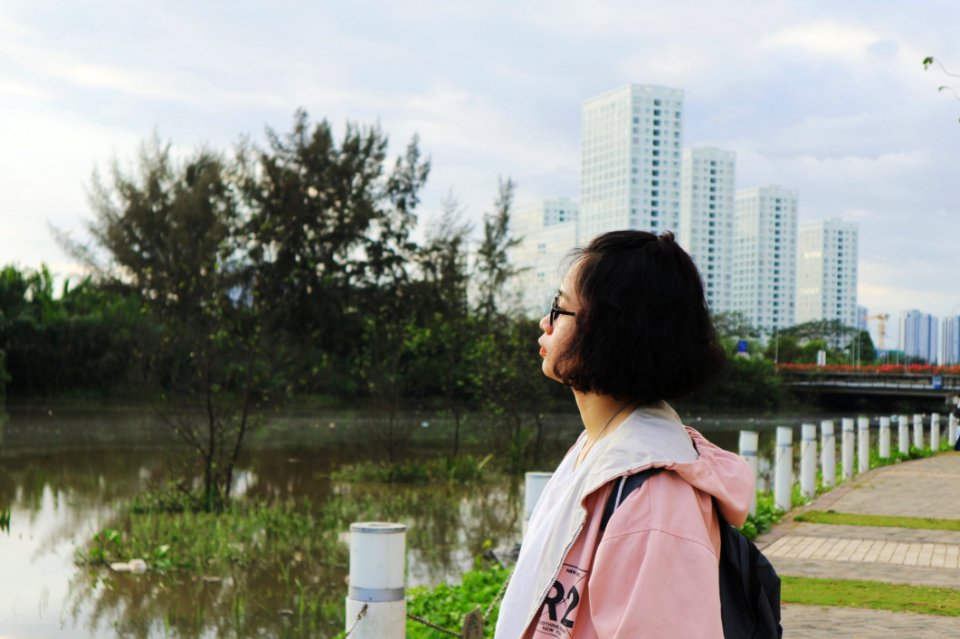 Woman Wearing Pink Hoodie Stand In Front Of Body Of Water