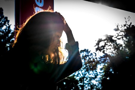 Woman Looking Holding While Holding Head With Left Hand photo