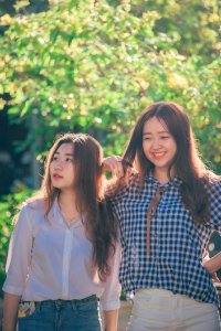 Woman Standing Near Woman Beside Trees