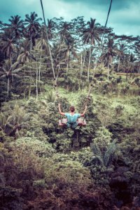 Woman Sitting On Wood Plank In Zip-line photo