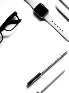 Closed Apple Watch Beside Eyeglasses On Table photo