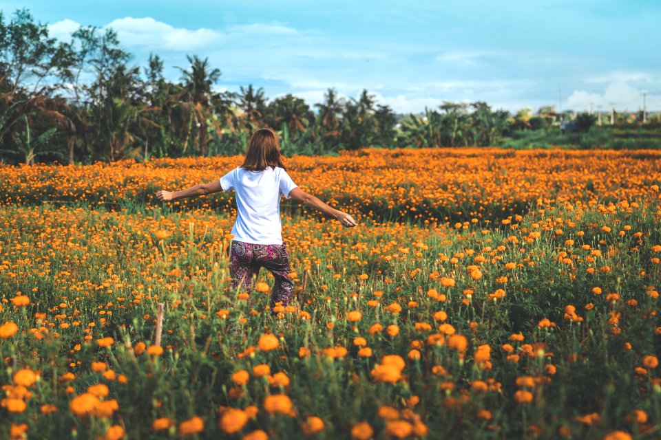 Girl Running On Yellow Flowers